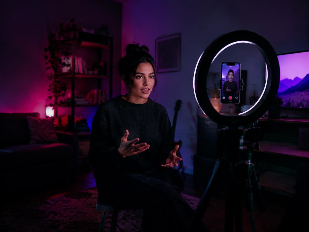 Contributor recording a video with a phone and ring light